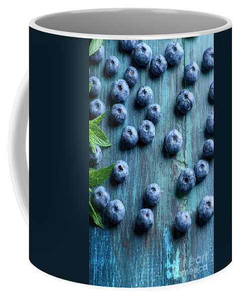 Blueberries Coffee Mug featuring the photograph Blueberries on blue wooden table by Jelena Jovanovic