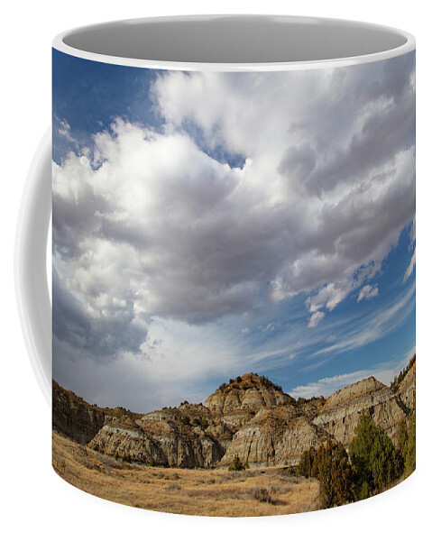 Buffalo Coffee Mug featuring the photograph Clouds over mountains at Theodore Roosevelt National Park in North Dakota by Eldon McGraw