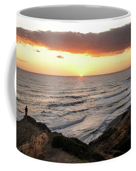 Sea Coffee Mug featuring the photograph Couple hugging at the edge of a cliff during a dramatic sunset by Michalakis Ppalis