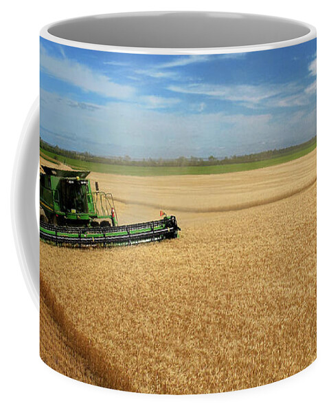 John Deere Coffee Mug featuring the photograph Full Hopper - John Deere combine harvesting wheat on rolling ND prairie by Peter Herman
