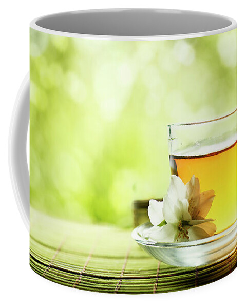 Tea Coffee Mug featuring the photograph Herbal cup of tea on wooden table by Jelena Jovanovic