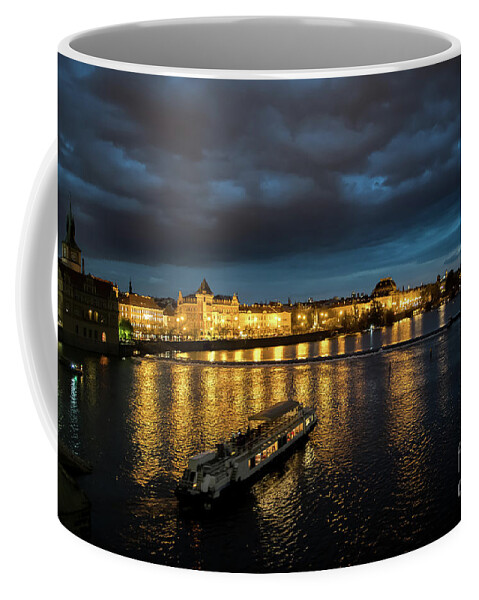 Architecture Coffee Mug featuring the photograph Illuminated Moldova River With Ship And Buildings In The Night In Prague In The Czech Republic by Andreas Berthold