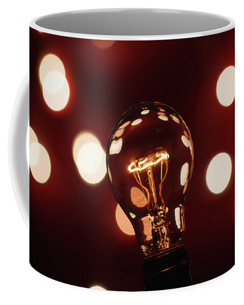 Light Bulb Coffee Mug featuring the photograph Light Bulb Bokeh by Gary Geddes