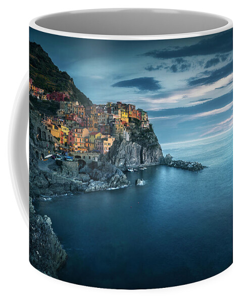 Manarola Coffee Mug featuring the photograph Manarola village, rocks and sea in blue hour. Cinque Terre, Ital by Stefano Orazzini