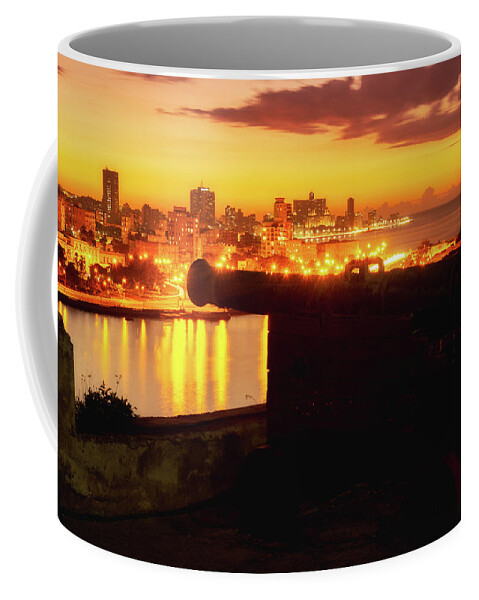 Cuba Coffee Mug featuring the photograph Old cannon and the city of Havana at sunset by Karel Miragaya