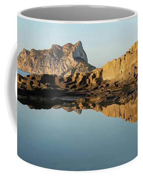Mediterranean Coffee Mug featuring the photograph Reflection of rocks in the calm Mediterranean Sea at sunrise 3 by Adriana Mueller
