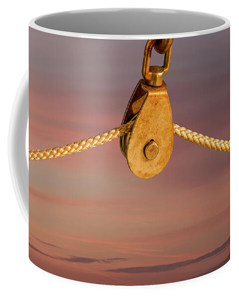 Closeup Coffee Mug featuring the photograph Rope on Pulley Against Blue Background by Darryl Brooks