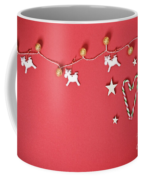 Seasonal Coffee Mug featuring the photograph Seasonal greeting card concept with Christmas lights and candy cane heart by Mendelex Photography
