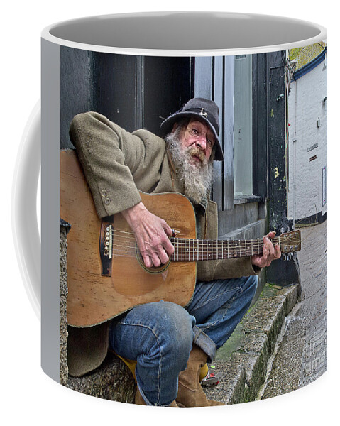 Singer Singing Guitar Audience Crow Character Portrait Effective Expressive Music Musician Laying Performance Hobbies Inspiration Candid St Ives Cornwall Unemployed Poor Homeless Rough Street Sleeping Beggar Begging Self-employed Talent Road Pavement Concert Moustache Beard Scene Theater Inspirational Solitary Solo Alone Eccentric Stage Actor Expression Weird Uncanny Grotesque Stranger Bizarre Sentimental Crow Beauty Public Passion Audience Hat Handsome Instrument Outside Lonely Heaven Lifestyle Coffee Mug featuring the photograph The audience - homeless singer gives guitar street concert UK by Tatiana Bogracheva