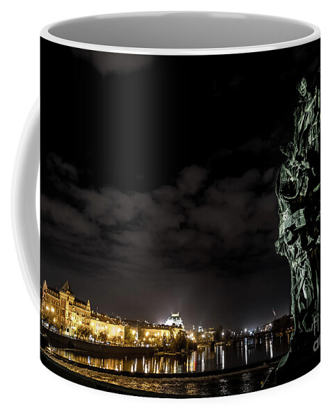 Ancient Coffee Mug featuring the photograph Statue On Charles Bridge And Illuminated Buildings In Prague In The Czech Republic by Andreas Berthold