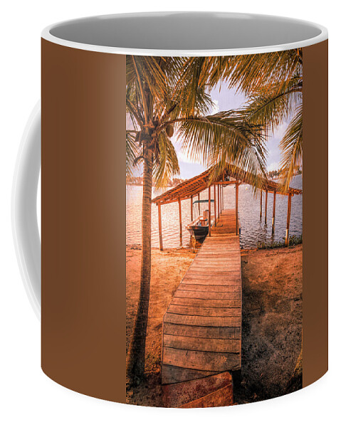 African Coffee Mug featuring the photograph Swaying Palms Over the Dock At Sunset by Debra and Dave Vanderlaan