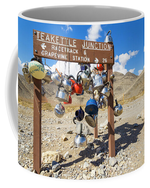 Road Coffee Mug featuring the photograph Teakettle Junction and road sign covered by kettles and pans, Death Valley National Park, California by Neale And Judith Clark