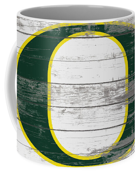 The Oregon Ducks Football Coffee Mug featuring the mixed media The Oregon Ducks  by Brian Reaves