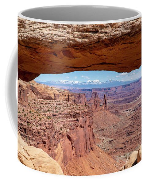 Canyonlands National Park Coffee Mug featuring the photograph The Washerwoman Arch is framed by the Mesa Arch at Canyonlands N by William Kuta