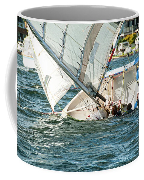 Cloud Coffee Mug featuring the photograph Two children in the water climbing back into a capsized sailboat by Geoff Childs