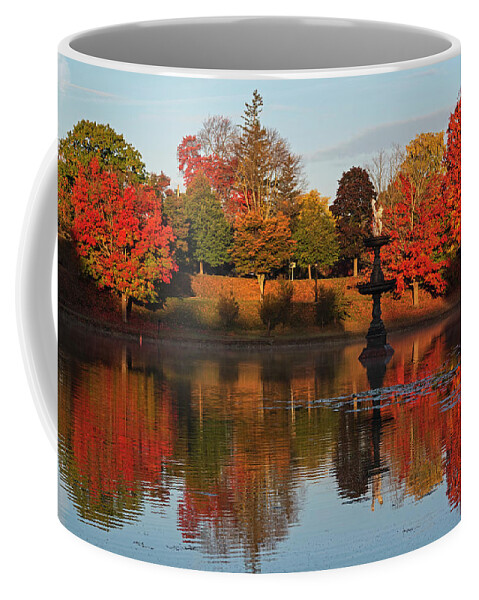 Newburyport Coffee Mug featuring the photograph Vibrant Fall Colors on the Newburyport Frog Pond Newburyport Massachusetts Fountain by Toby McGuire