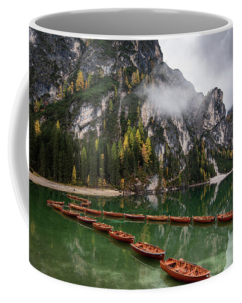 Lago Di Braies Coffee Mug featuring the photograph Wooden boats on the peaceful lake. Lago di braies, Italy by Michalakis Ppalis
