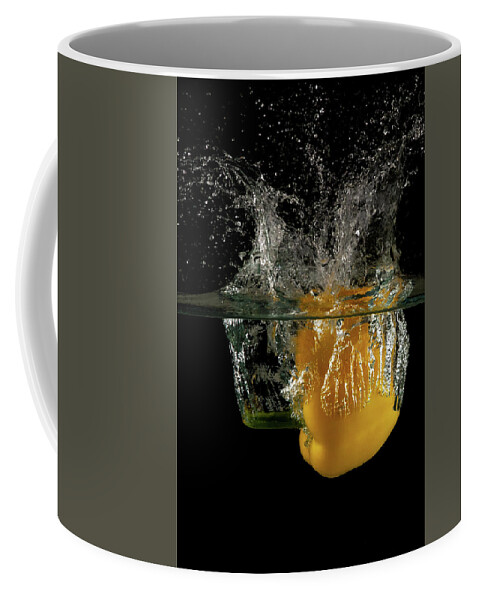 Pepper Coffee Mug featuring the photograph Yellow bell pepper dropped and slashing on water by Michalakis Ppalis