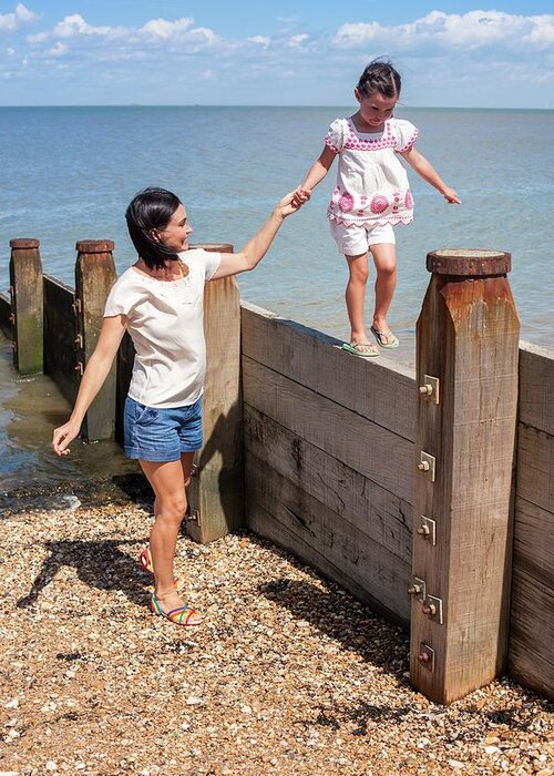 Two People Greeting Card featuring the photograph Mother And Daughter On Beach #1 by Ian Hooton