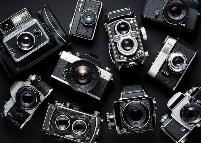 Black Background Greeting Card featuring the photograph Vintage Cameras #1 by Jorg Greuel