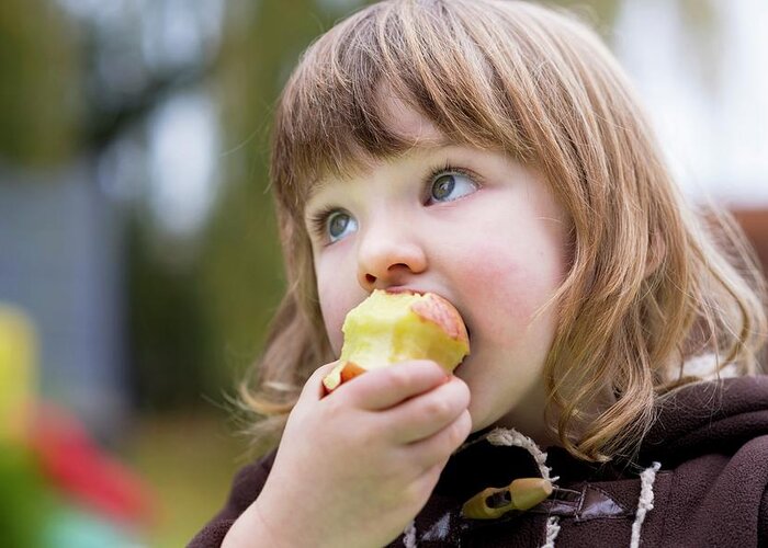 Day Greeting Card featuring the photograph Girl Eating An Apple #2 by Aberration Films Ltd
