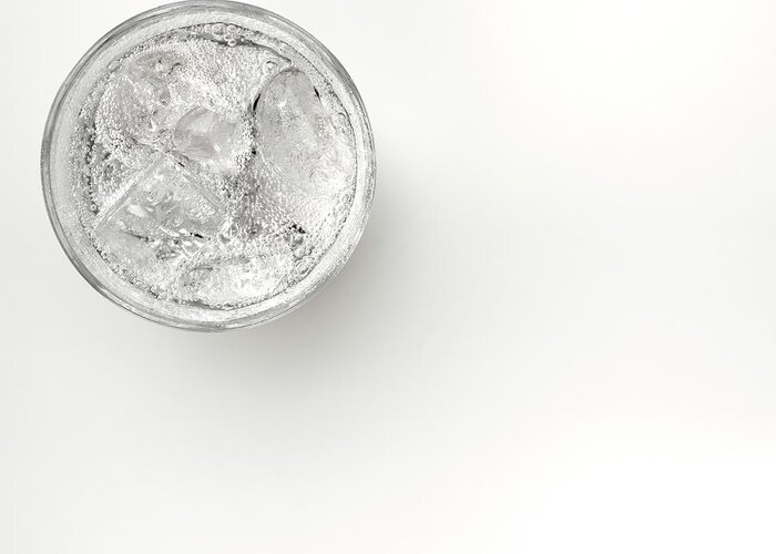 White Background Greeting Card featuring the photograph A Glass Of Sparkling Water With Ice by Anthony Bradshaw