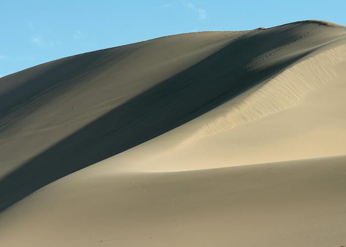 Shadow Greeting Card featuring the photograph A Large Sand Dune Against A Blue Sky by Keith Levit / Design Pics