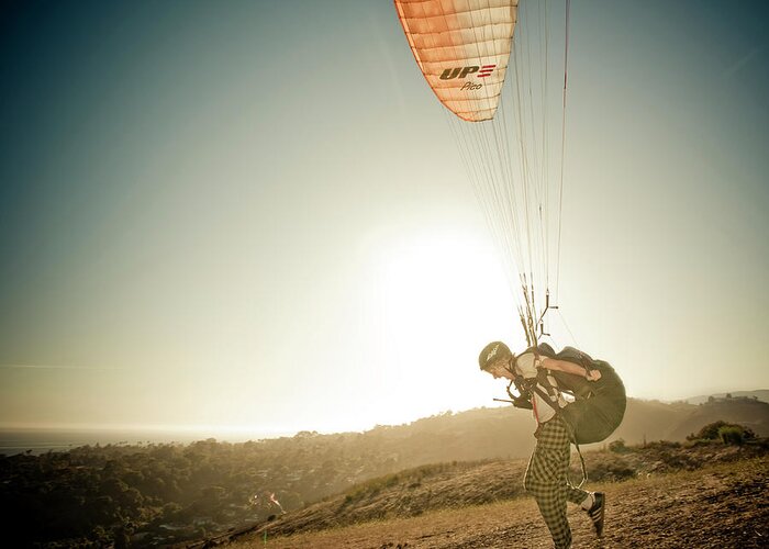 Adult Greeting Card featuring the photograph A Young Man Launches His Paraglider by Kevin Steele