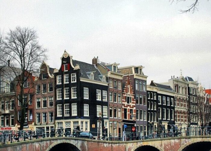 Canal Greeting Card featuring the photograph #amsterdam #canal #gables #bridge by Jason Emmett