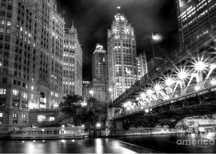 Modern; City; Cityscape; Road; Bridge; Outdoor; Outside; Perspective; Street; Transportation; Building; Chicago; Illinois; Downtown; Urban; United States; Lights; Road; Street; Michigan Avenue; Dusable Bridge; Sidewalk; Walkway; Lights; Boat; Night; Nighttime; Dark; Usa; Tribune Tower; River; Chicago River; Black And White; Monochrome Greeting Card featuring the photograph Boat Along the Chicago River by Margie Hurwich