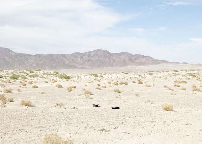 Scenics Greeting Card featuring the photograph Car Tire In Desert by Peter Starman