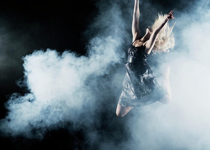 Human Arm Greeting Card featuring the photograph Dancer Leaping Through Smoke by Henrik Sorensen