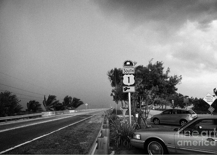 Dark Greeting Card featuring the photograph Dark Rain Storm Clouds Blow Over The Seven Mile Bridge Marathon Key Car Park Florida Keys Usa by Joe Fox