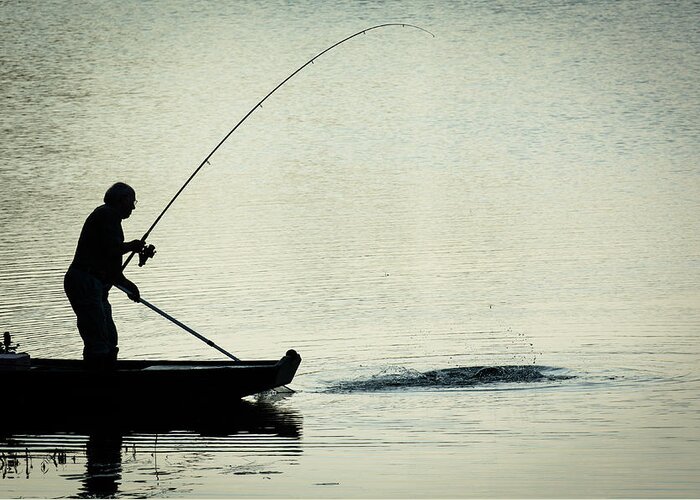 Fisher Greeting Card featuring the photograph Fisherman Catching Fish On A Twilight Lake by Andreas Berthold