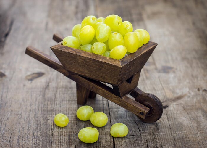Fruit Greeting Card featuring the photograph Fresh Green Grapes in a wheelbarrow by Aged Pixel