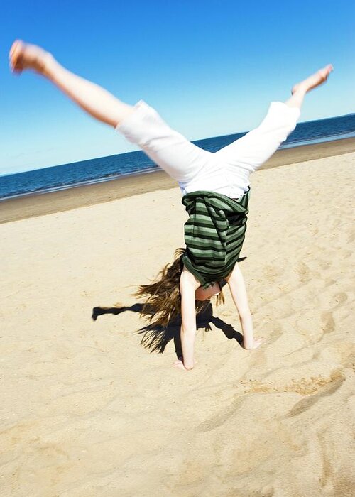 Human Greeting Card featuring the photograph Girl Doing A Cartwheel by Gustoimages/science Photo Library