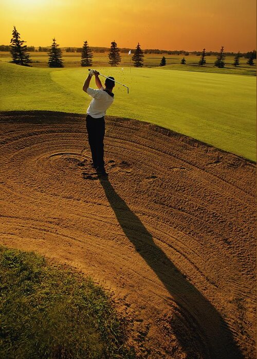 Twilight Greeting Card featuring the photograph Golfer Taking A Swing From A Golf Bunker by Darren Greenwood