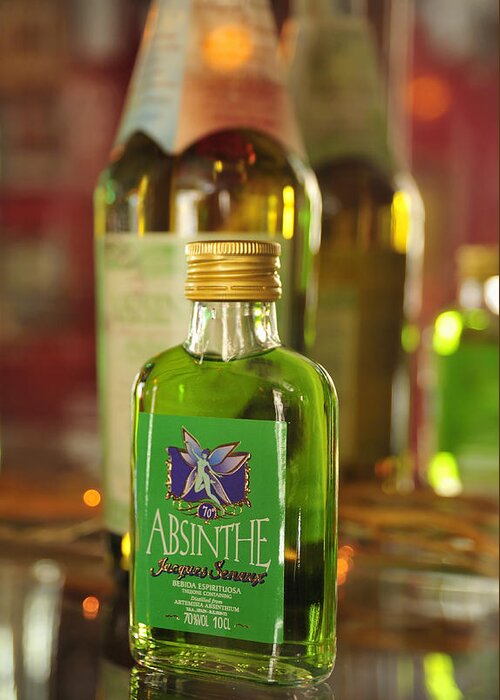 Absinthe Greeting Card featuring the photograph Green Absinthe in small bottle by Matthias Hauser