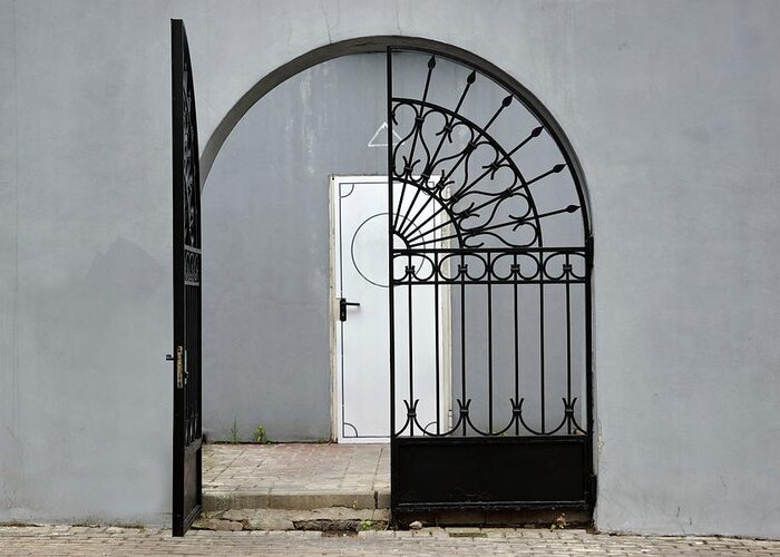 Arch Greeting Card featuring the photograph Grey Wall With Iron Gate And Door In by Avnphotolab