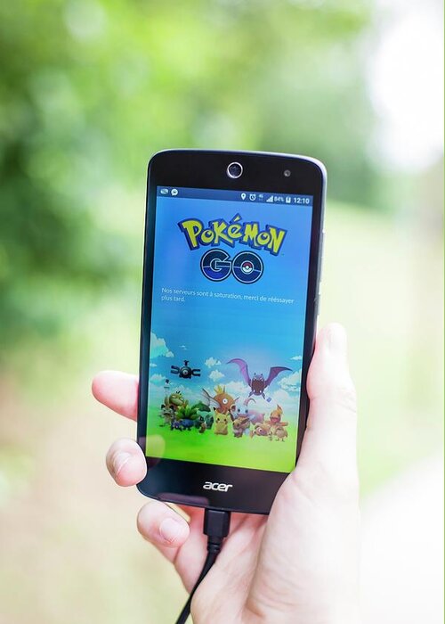 Pokemon Go Greeting Card featuring the photograph Interactive Smartphone Game by Stg/jonas Gilles/reporters/science Photo Library