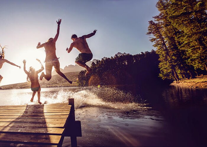 Child Greeting Card featuring the photograph Jumping Into The Water From A Jetty by Wundervisuals