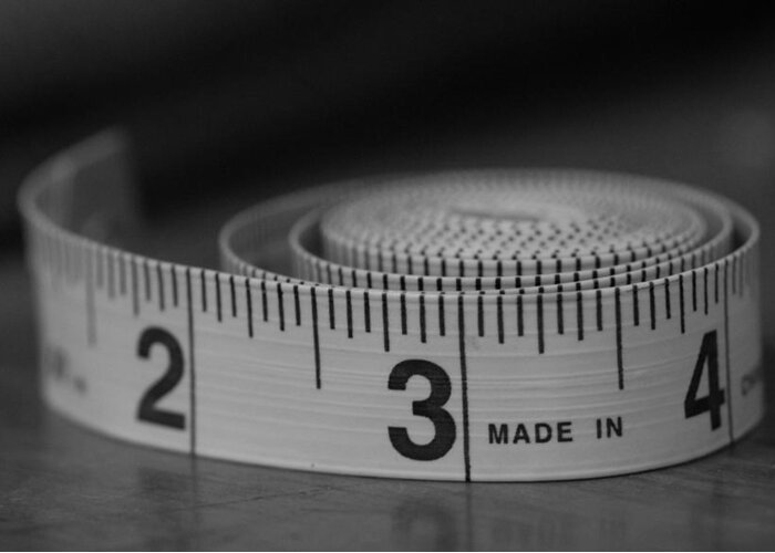 Tape Measure Greeting Card featuring the photograph Measuring Up by Holden The Moment