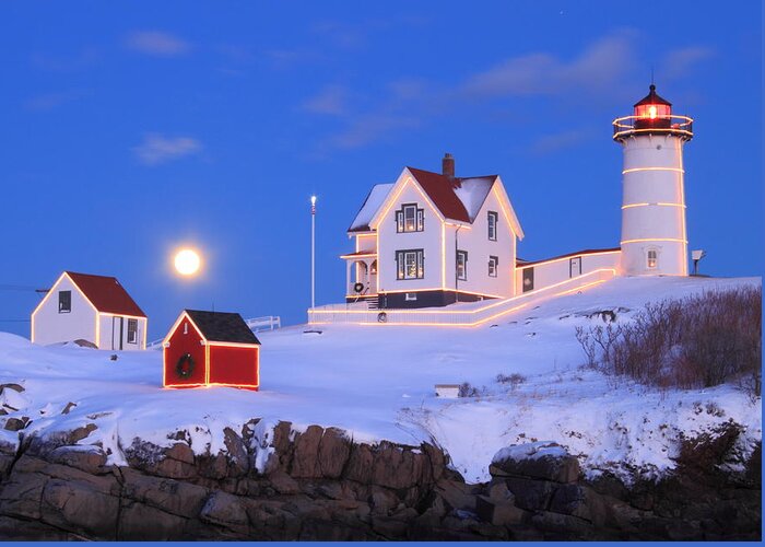 Lighthouse Greeting Card featuring the photograph Nubble Lighthouse Full Moon and Holiday Lights by John Burk
