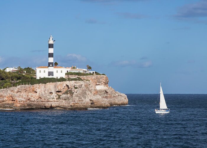 Sailboat Greeting Card featuring the photograph Porto Colom Lighthouse With Sail Boat by Paul Boyden - Polimo