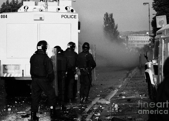 Northern Greeting Card featuring the photograph PSNI riot officers behind water canon during rioting on crumlin road at ardoyne shops belfast 12th J by Joe Fox