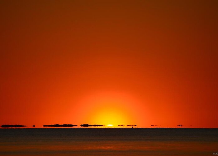 Navarre Greeting Card featuring the photograph Red Sunset with Superior Mirage on Santa Rosa Sound by Jeff at JSJ Photography