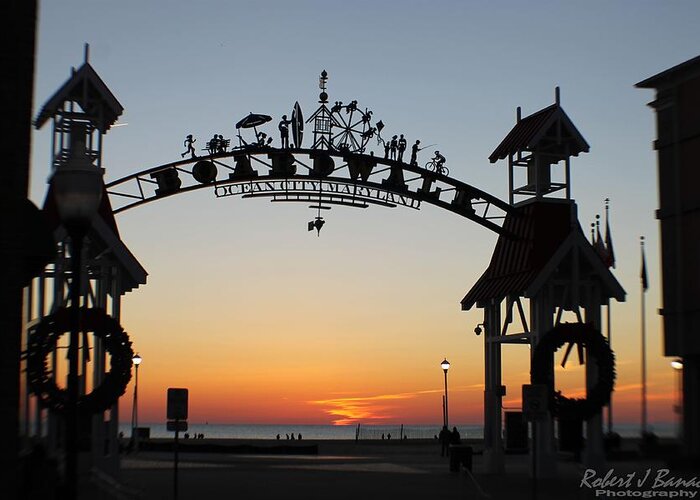 Sunrise Greeting Card featuring the photograph Sun Reflecting on Clouds Ocean City Boardwalk Arch by Robert Banach