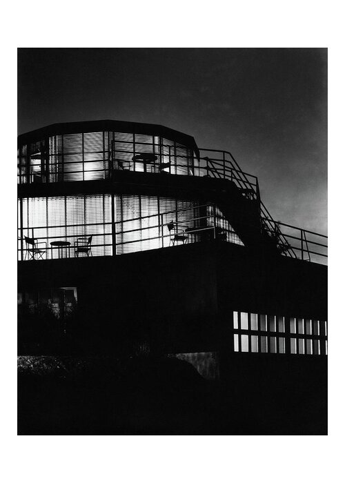 Home Greeting Card featuring the photograph The Exterior Of A Spiral House Design At Night by Eugene Hutchinson