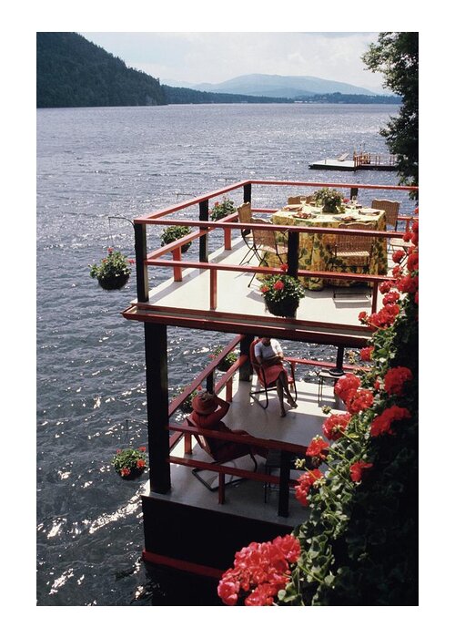 Home Water Adirondack Mountains New York State Usa North America Mid-atlantic Outdoors Daytime Topiary Landscape Architecture Plants Ornamental Garden Table Furniture Chair Flower Two People People 30-34 Years Mid-adult 30s Adult Male Mid Adult Man Female Mid Adult Woman Sitting Shadow Ben Wyker Judith Garden Wyker Deck Chair Outdoor Furniture Lake Mountain #condenasthouse&gardenphotograph August 1st 1975 Greeting Card featuring the photograph The Wyker's Deck by Ernst Beadle