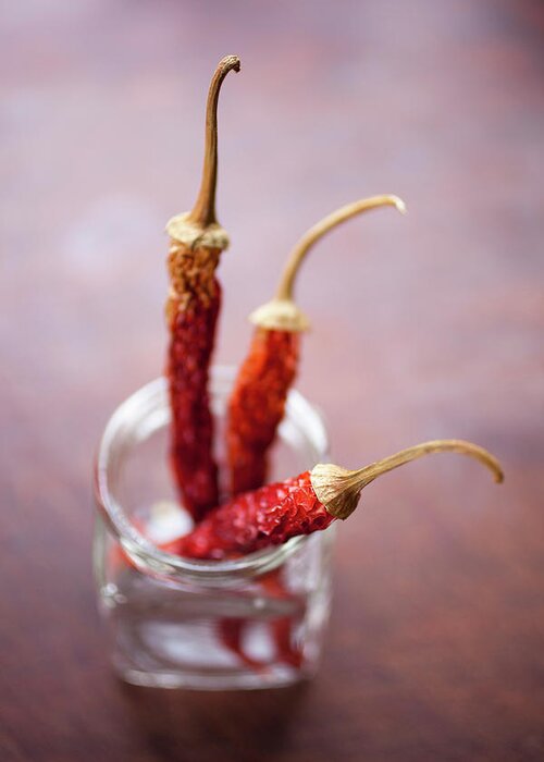 Spice Greeting Card featuring the photograph Three Dried Chilies In A Glass Jar by Tobias Titz